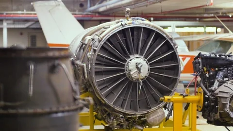 Rack focus of Aircraft turbo engine on display in aircraft maintenance hanger Stock Footage 112671824
