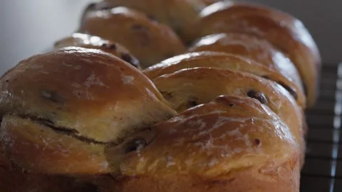 Rack focus along the glazed top of a chocolate chip brioche 库存影片 345367450