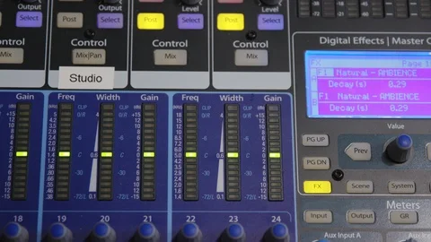 Rack focus to an audio recording studio audio mixing board Stock Footage 89579927