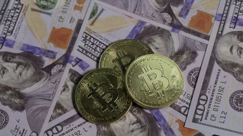 Rack focus away from bitcoins and money united states currency Stock Footage 84240560