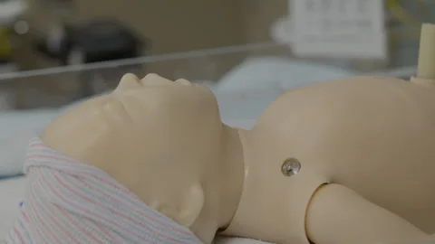 Rack focus to baby medical doll Stock Footage 301336953