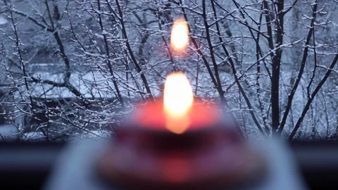 Rack focus of a beautiful, circular candle holder with a lit candle in the Stock Footage 128331274