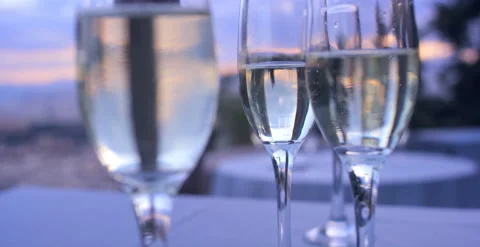 Rack focus between champagne glasses in front of Athens, Greece at sunset 스톡 동영상 202256755