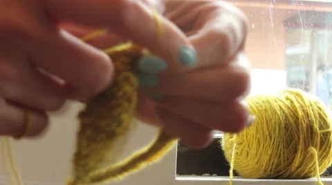 Rack Focus Between Hands Knitting And Yarn Video stock 43107771