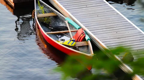 Rack Focus Between Leaves and Classic Red Canoe Stock Footage 66563010