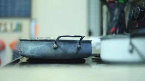 Rack focus between pans on stove Stock Footage 90354782