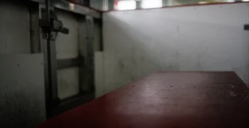 Rack focus between player bench and door onto the ice at hockey rink Stock Footage 85869088