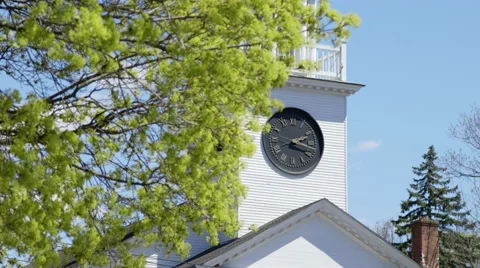 Rack focus between spring foliage and clock tower face Stock Footage 49936433