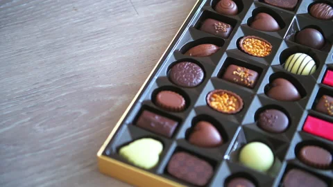 Rack focus of box of chocolates milk and dark desserts Stock Footage 165300495