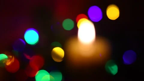 Rack focus on burning candle with green fir Stock Footage 131159963
