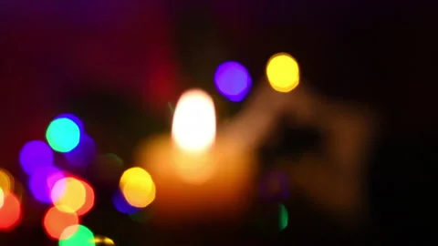 Rack focus on burning candle with green fir Stock Footage 131160274