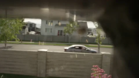 Rack focus from car passing on road to orb weaver spider under railing Video stock 146921108