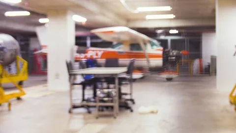 Rack focus of Cessna 150 parked in the hanger for maintenance and service Stock Footage 112671737