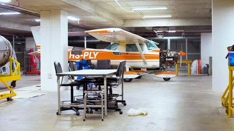 Rack focus of Cessna 150 parked in the hanger for maintenance and service Video stock 112671951