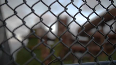 Rack Focus from Chain Link Fence to Abandoned Factory Stock Footage 114428956