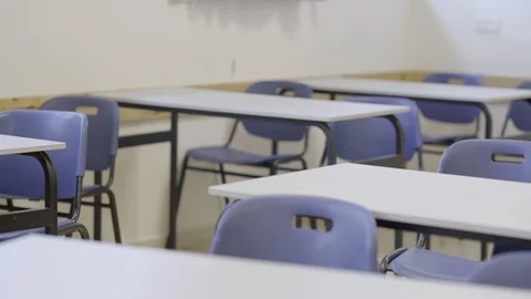 Rack focus from chairs in classroom background to foreground - empty classroom Stock Footage 125941066
