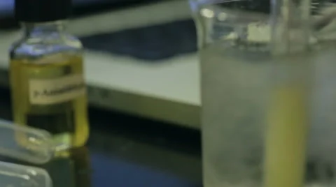 Rack focus of chemical mixing experiment Video stock 37995100