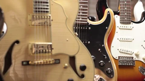 Rack focus close up CU three electric guitars Stock Footage 56036244