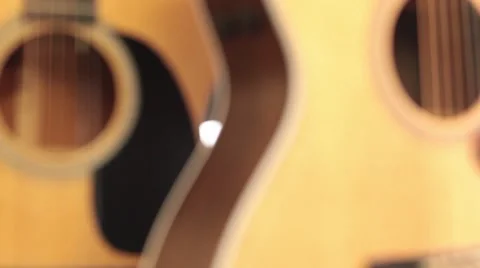 Rack focus close up CU upright acoustic guitars Stock Footage 56036256