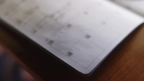 Rack focus close up of a planner calendar on a desk Video stock 134281019