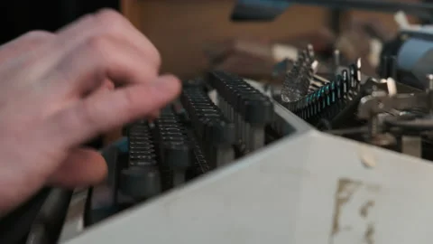 Rack focus close up typebars of old antique typewriter. Man printing something Stock Footage 150666016