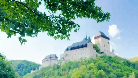 Rack focus close up view of Karltejn Castle through trees Stock Footage 316585524