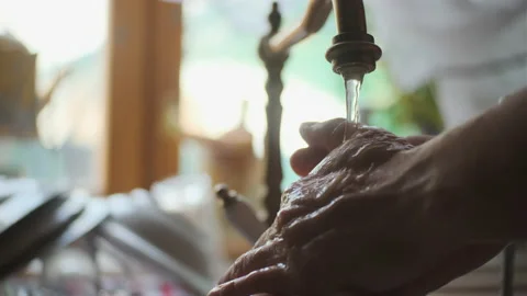 Rack focus close up view of men hands opening copper tap in old kitchen and Stock-Footage 158130488