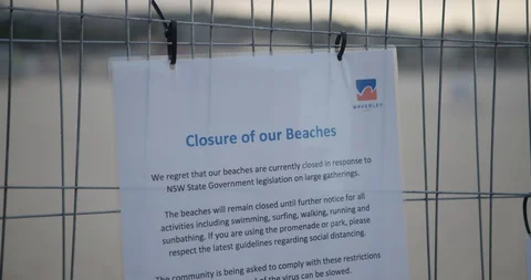 Rack focus from Closed sign to deserted Bondi Beach, COVID-19 動画素材 128043860