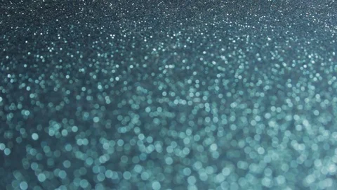 Rack focus closeup shot of black and blue glitter Stock Footage 92323749