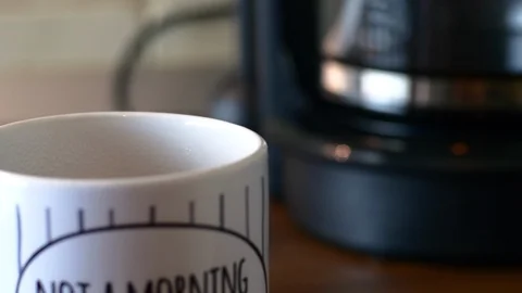 Rack Focus From A Coffee Mug To The Coffee Maker, Morning Ritual Stock-Footage 85556340