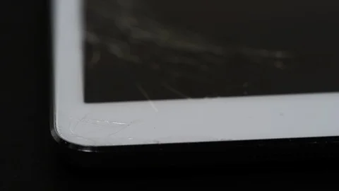 Rack focus to cracked display on tablet computer Stock Footage 86778533