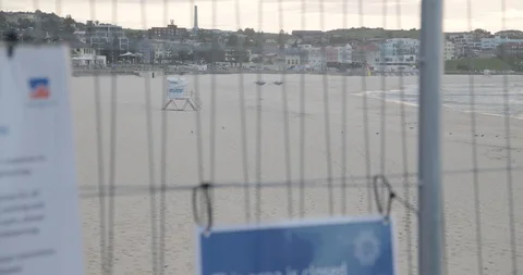 Rack focus from deserted Bondi Beach to Closed sign, COVID-19 動画素材 128043047