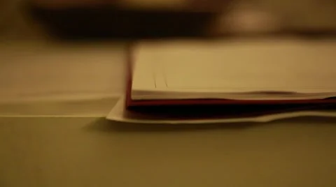 Rack focus of documents on a table Video stock 64804514