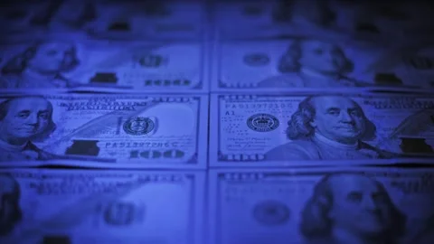 Rack Focus on Dollar Bills in Blue UV Light Stock Footage 320355348