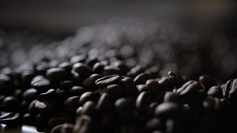 Rack focus dynamically lit coffee beans Stock Footage 94359299