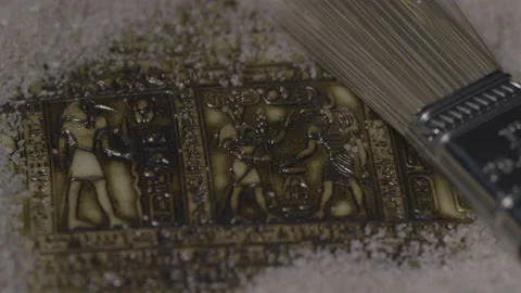 Rack focus to egyptology tablet discovery Stock Footage 141529913