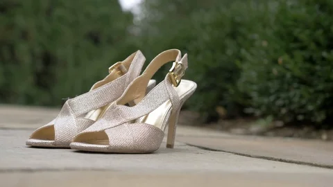 Rack Focus of Fancy High Heel Shoes on the Ground Outside Video stock 89349873