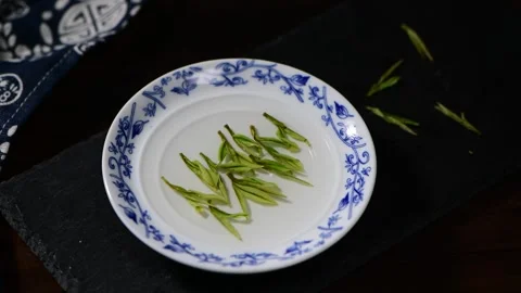 Rack Focus on Fresh Green Tea Leaves in Chinese Blue and White Porcelain Plate Stock Footage 340302889