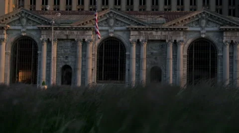 Rack focus from grass blowing in the wind to Michigan Central Station Stock Footage 47038735