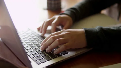 Rack focus of hands working on a laptop using the trackpad Video stock 134279939