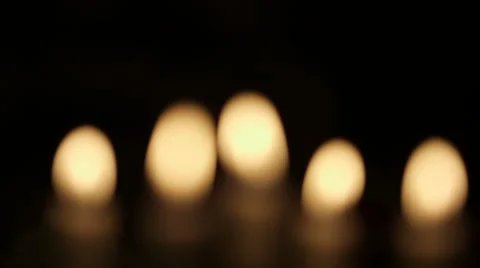 Rack focus on lit candles Stock Footage 64978491