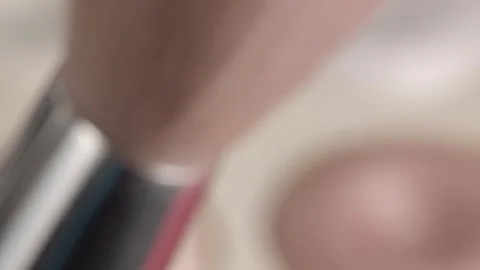 Rack Focus From Makeup Brush to Shimmering Eyeshadow Palette Closeup Stock Footage 340808268