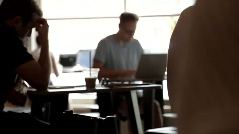 Rack Focus Man Typing on Laptop in Coffee Shop 스톡 동영상 100074740