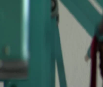 Rack focus on mechanical arms catching newly ironed cloth Stock Footage 21593634