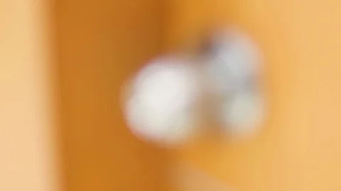 Rack focus of metallic door knob on wooden door Stock Footage 124649724