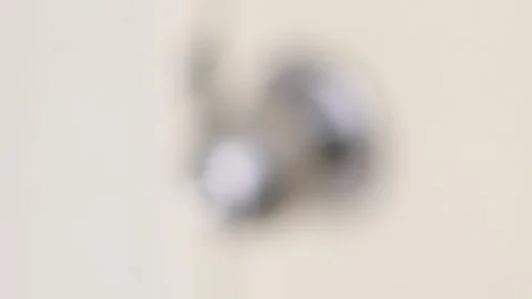 Rack focus of metallic door knob Stock Footage 124649862