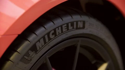 Rack focus michelin tire on red porsche 718 cayman gts Stock Footage 229808942