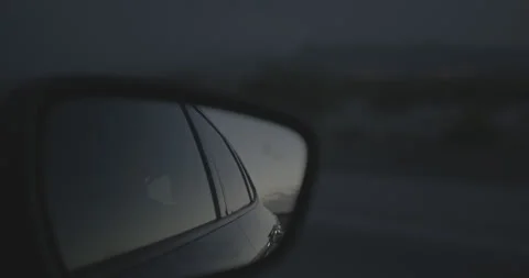 Rack Focus to Mirror from Mountains Handheld in a Car Stock Footage 246510762