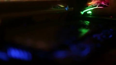 Rack focus from a multi-colored keyboard to a mouse Stock Footage 333706833