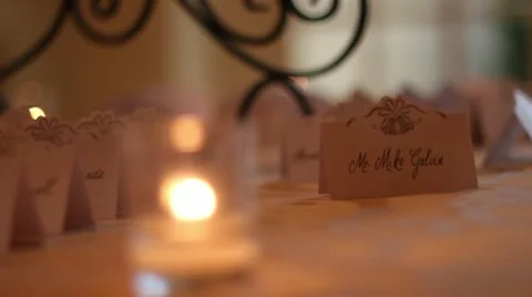 Rack focus from name tag to candle CU Vídeo Stock 11137945
